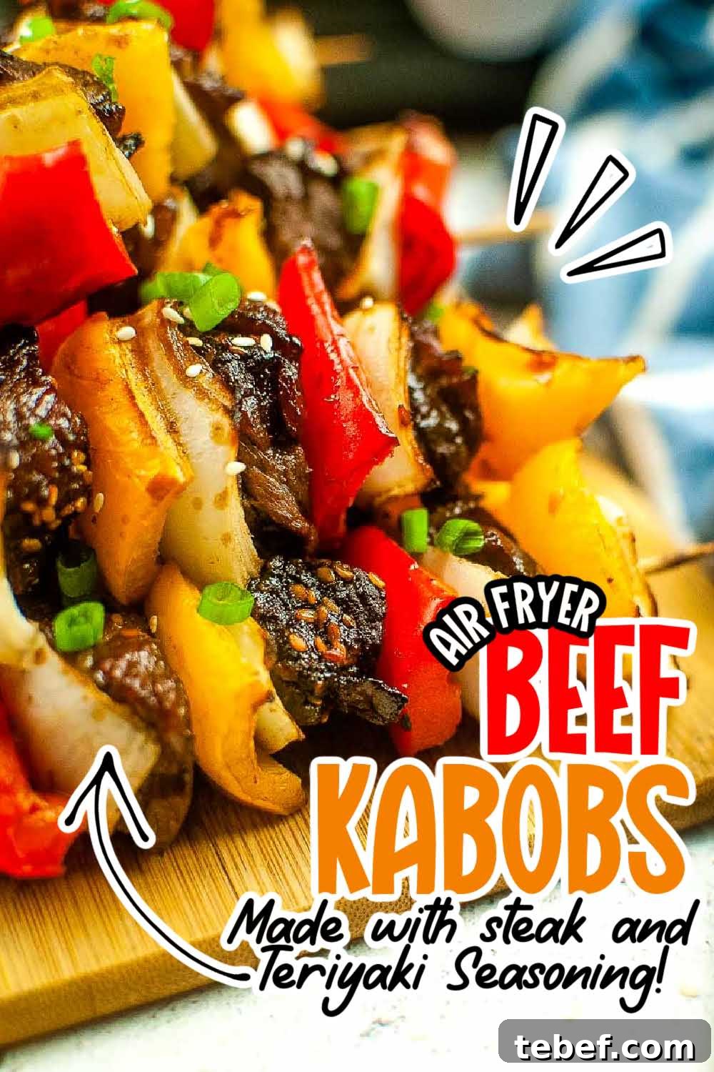 Air fried beef kabobs with peppers and onions on a wooden cutting board with text overlay.